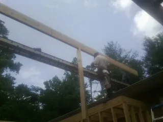 Carpenter setting a ridge beam over a new addition frame — Ice Dam Removal by Roofing Brothers in Tunkhannock