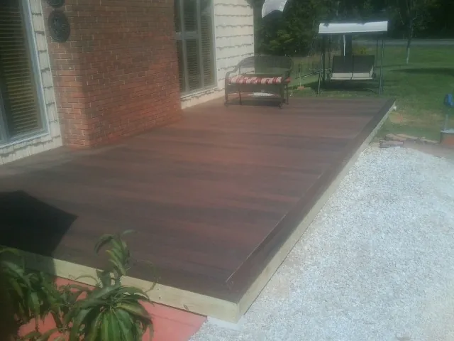 Freshly stained wood deck built against a brick home in Tunkhannock
