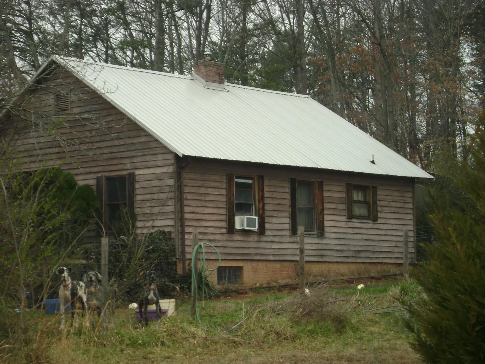 White metal roof on an old wood sided farmhouse, from a Metal Roof Installation job in Tunkhannock